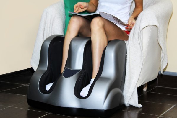 woman getting a foot massage foot massager